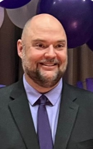 photo of man smiling in a suit