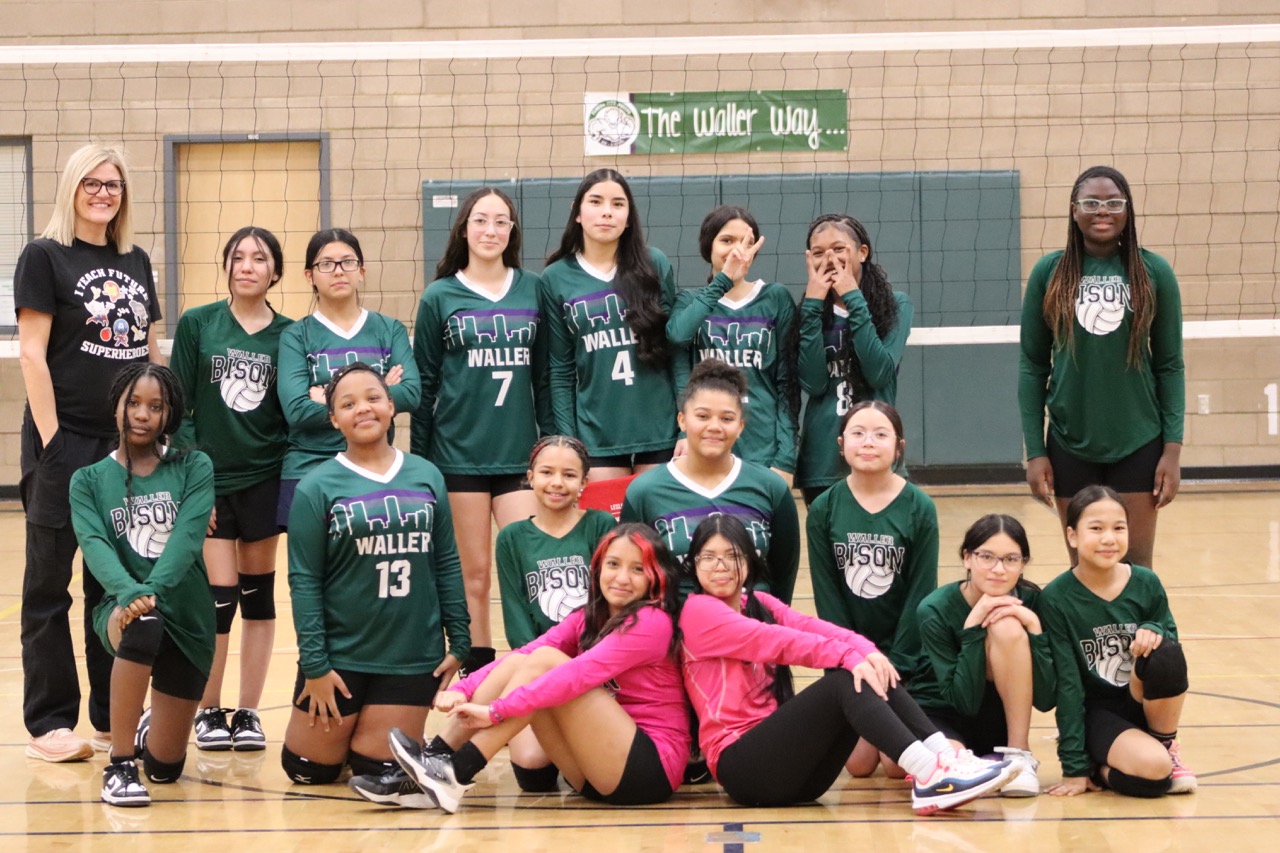 girls volleyball team posing for a photo